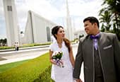 A newlywed couple walking on temple grounds