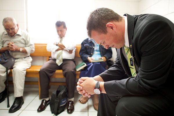 Missionary giving a prayer in Sunday School